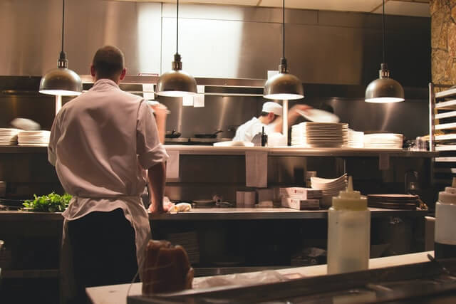 Trang Chủ chef standing in restaurant kitchen